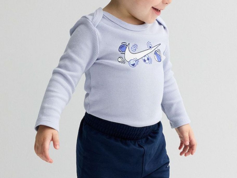 kid wearing Baby Boys Nike Sports Balls Long Sleeve Bodysuit & Pants 2-Piece Set