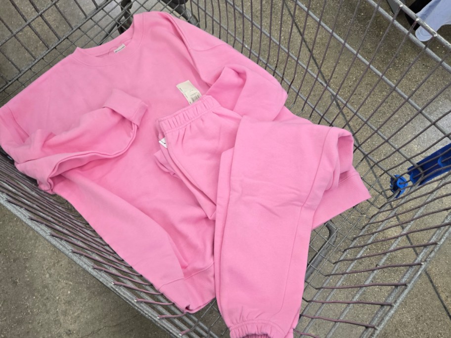 Pink No Boundaries sweat shirt and pants in a cart at Walmart.