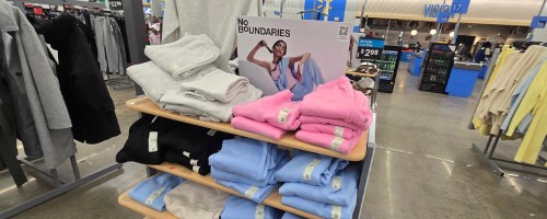 gray, black, pink and blue sweats folded on display