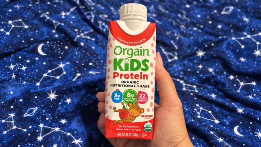 hand holding protein shake carton