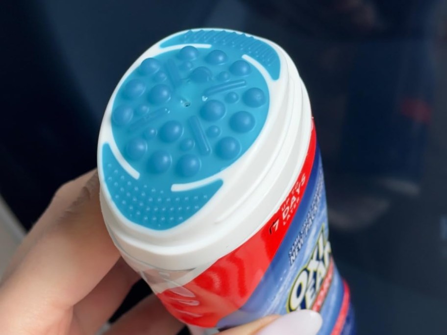 holding a gel stain stick with the lid off