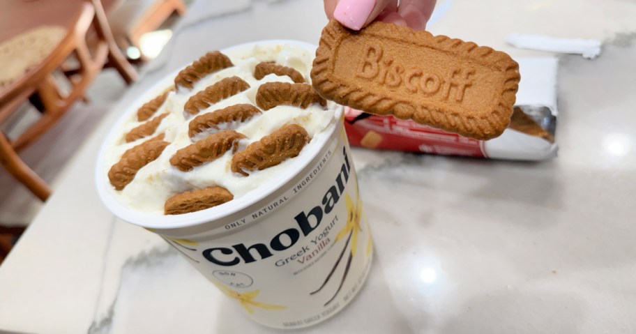 placing biscoff cookies inside a yogurt container