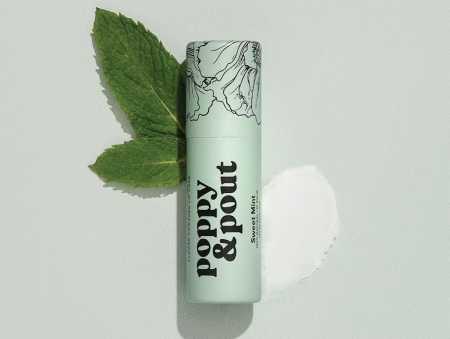 stock photo of poppy and pout chapstick sweet mint with mint leaves