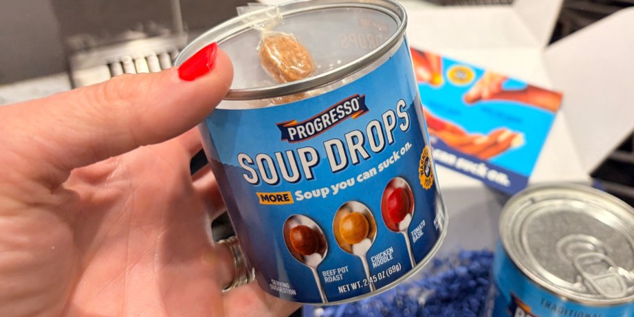 hand holding pregresso soup drop can