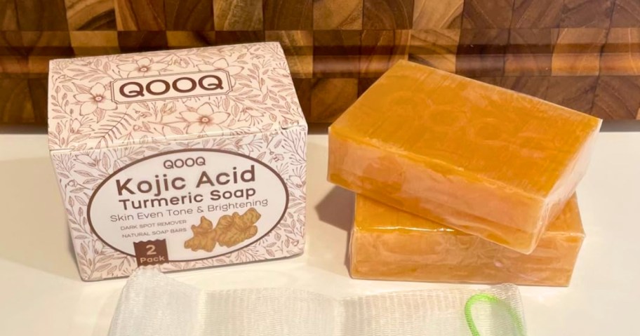 two bars of soap next to the box they come in