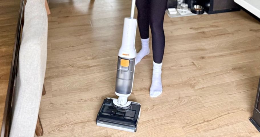 person using Roborock All-in-1 Vacuum on floor