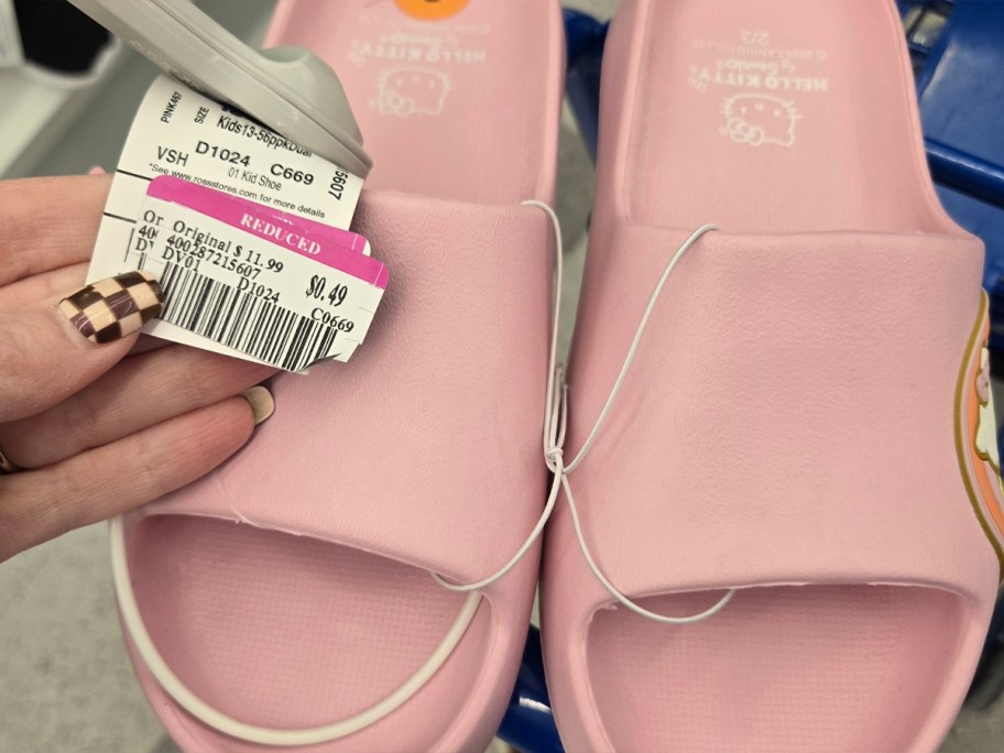 hand holding pink sandals with ross clearance tag