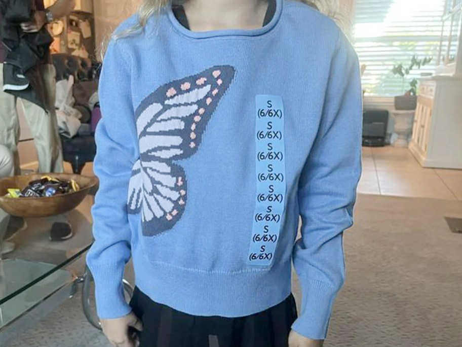 kid wearing blue butterfly sweater