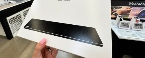 hand holding a box with a samsung galaxy tablet in it