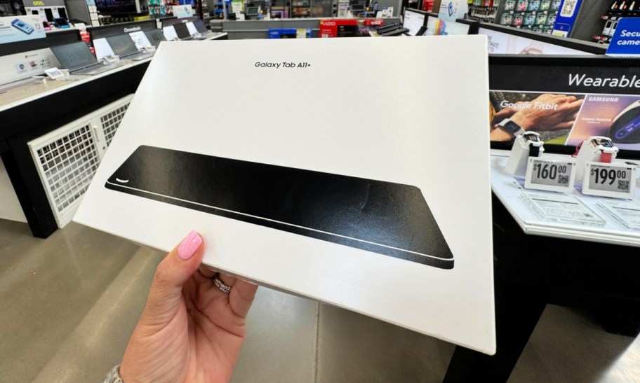 hand holding a box with a samsung galaxy tablet in it