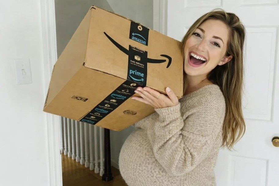 pregnant woman holding up amazon box