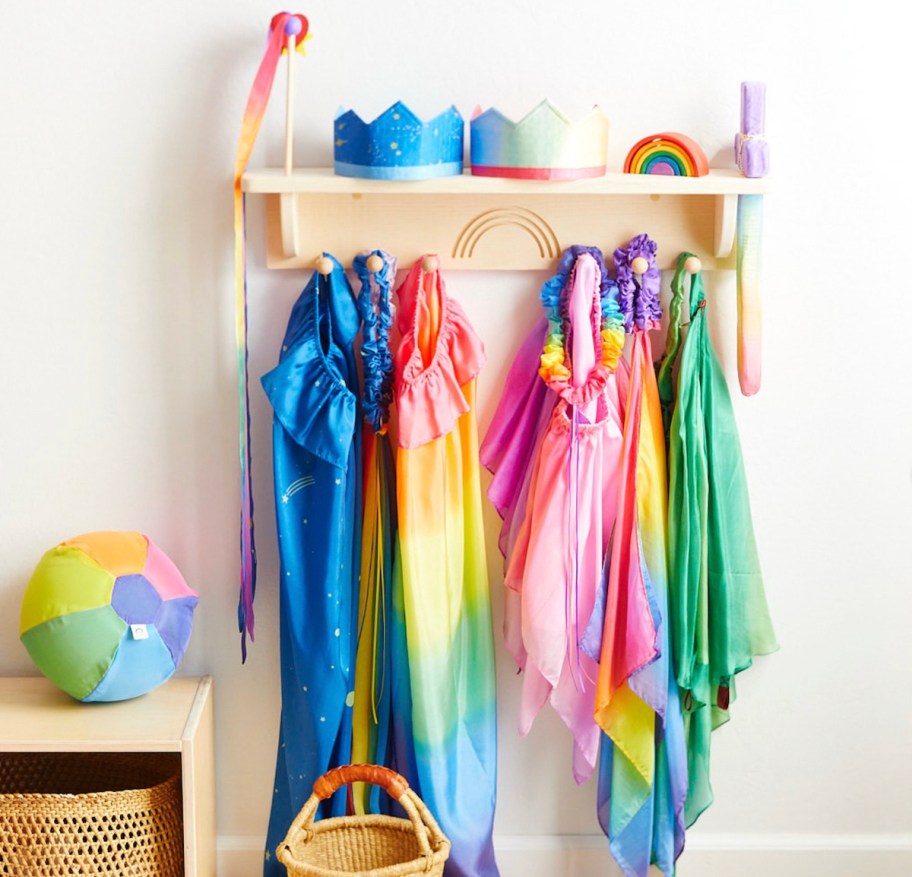 colorful rainbow silk fabrics hanging on wood shelf