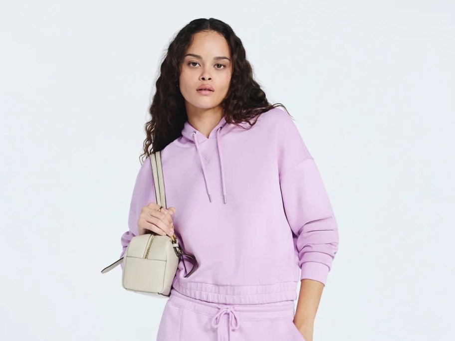 woman wearing purple hoodie on white background