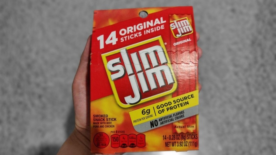 mans hand holding a slim jim 14 count snack size box