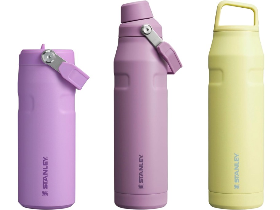 two purple and one yellow stanley water bottles 