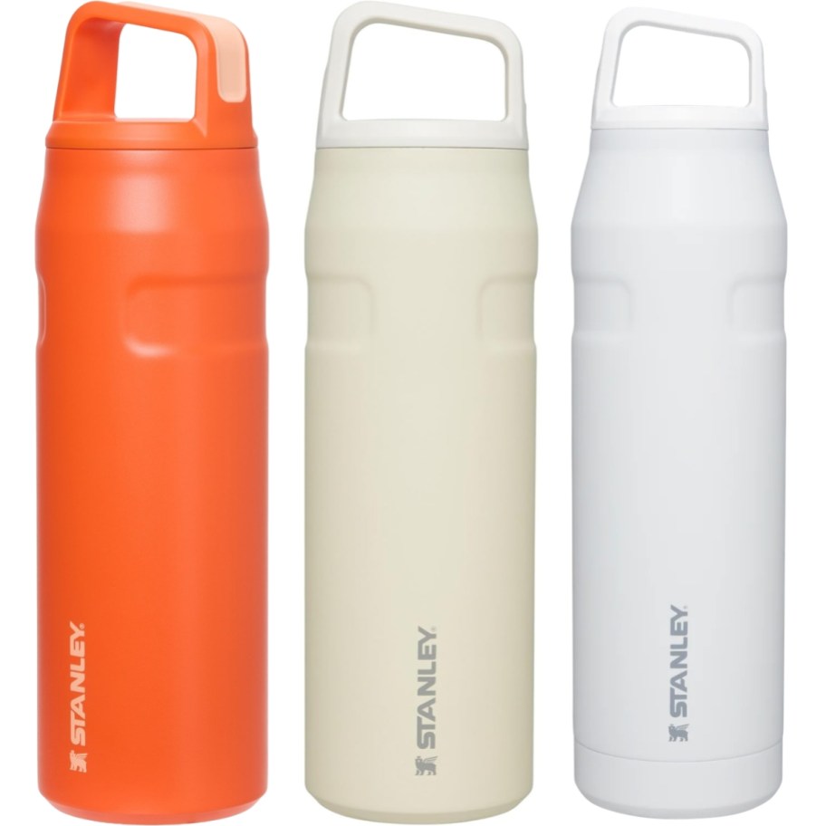 three stanley water bottles in 3 different colors