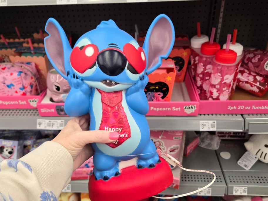 A hand holding up a Valentine's Stitch figurine.