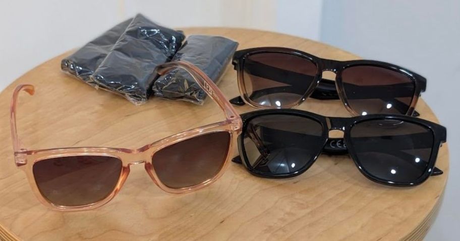 three woman's sunglasses on stool