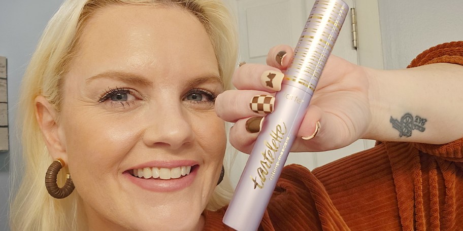 woman holding tartlette mascara