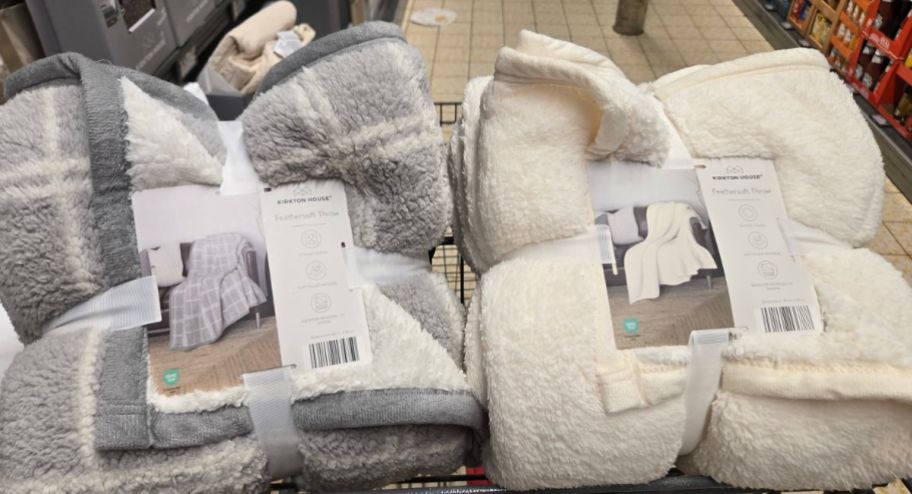 two different color throw blankets inside of shopping cart