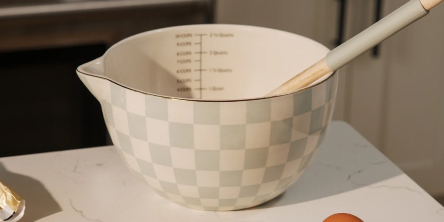 green and white checkered mixing bowl on table