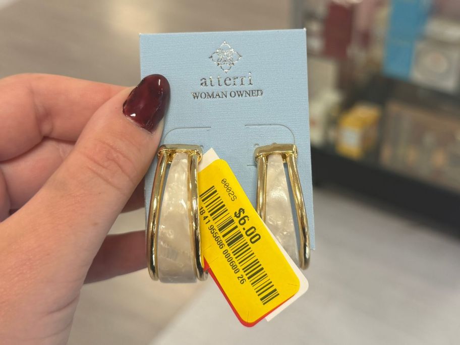 hand holding earrings in tj maxx store