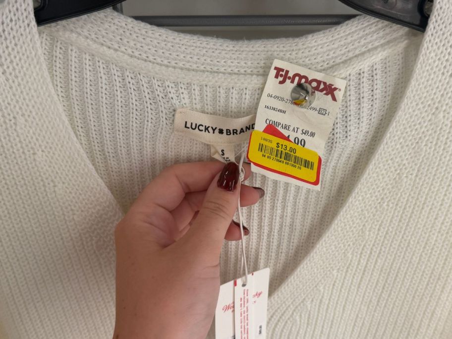 hand holding tag on lucky brand sweater at tj maxx
