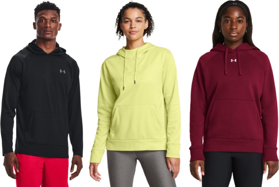 Three people wearing various colors of Under Armour hoodies.