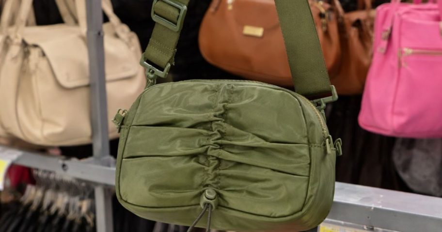 green walmart shoulder bag with other bags in the background