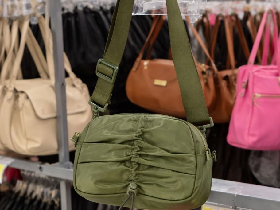 green walmart shoulder bag with other bags in the background