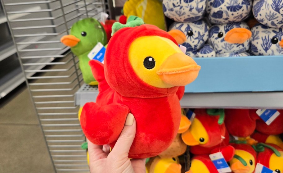 hand holding plush duck with pepper 