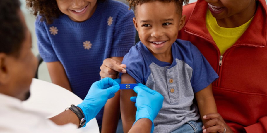 doctor putting bandaid on child