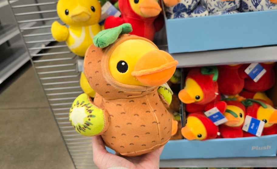 hand holding duck in kiwi outfit 