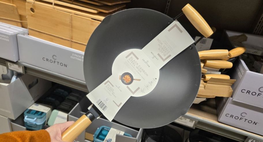 hand holding a frying wok pan