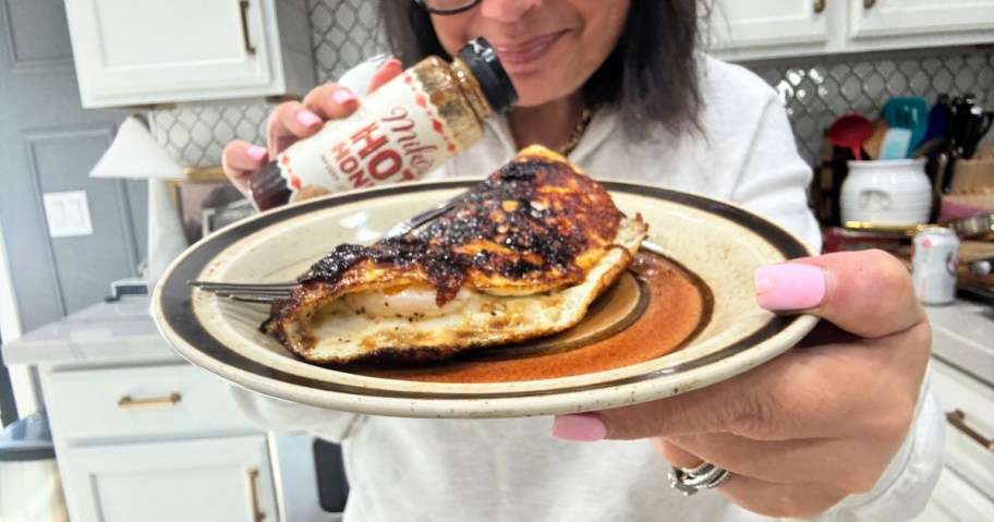 woman holding hot honey skillet eggs