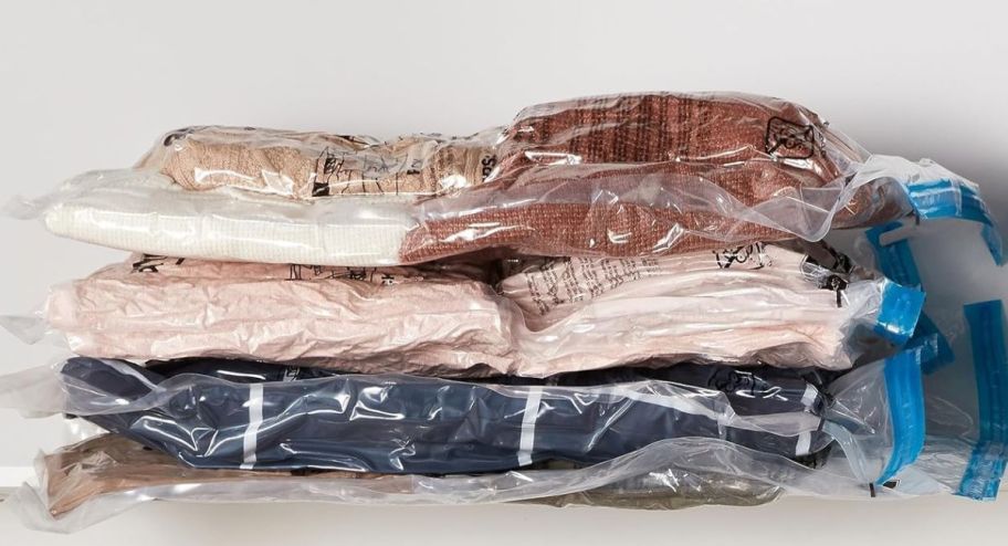 compression storage bags with items inside displayed up top of a closet