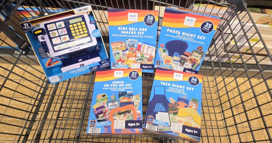ALDI shopping cart with playsets inside of it