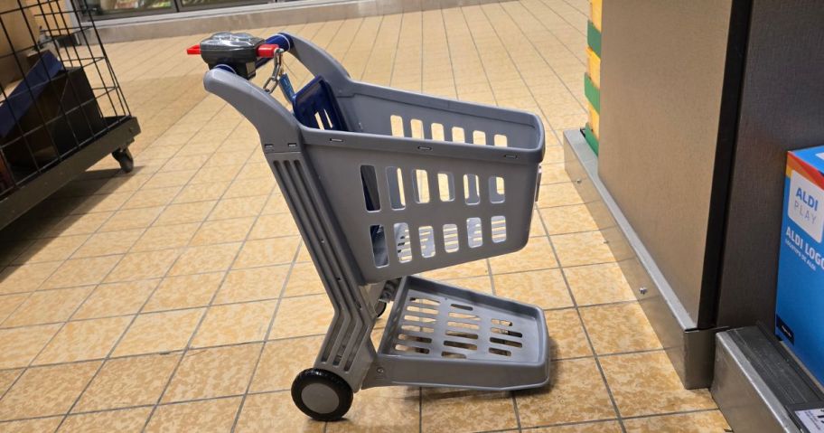 ALDI shopping cart toy displayed on the floor