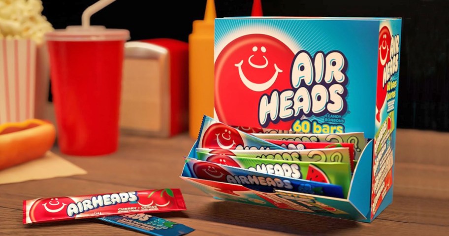 opened box of Airheads with candies on table in front of it