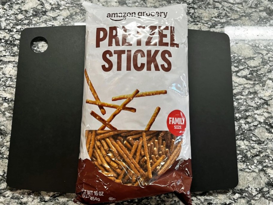 bag of Amazon Grocery Pretzel Sticks on a black cutting board on a counter