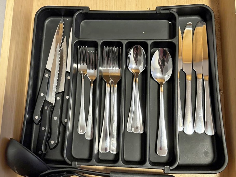 silverware in a black silverware organizer in drawer