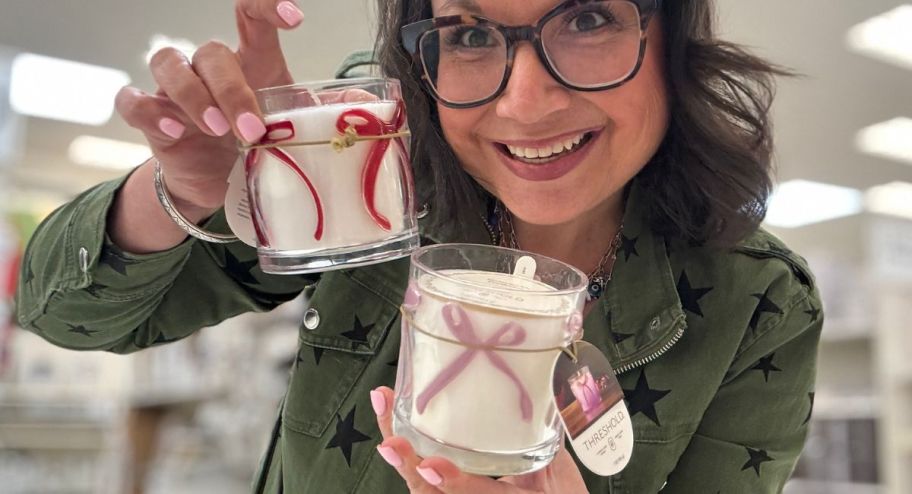 woman holding two bow candles from target