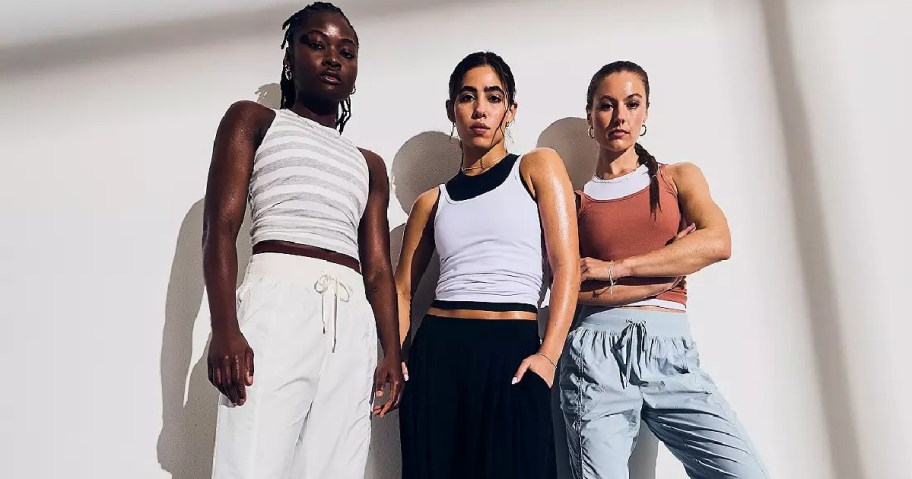 Three women stand confidently in stylish Calia activewear, against a white background.
