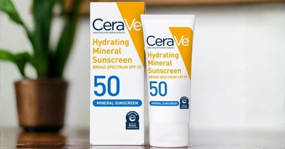 bottle and box of cerave spf 50 mineral sunscreen on table with plant in the background