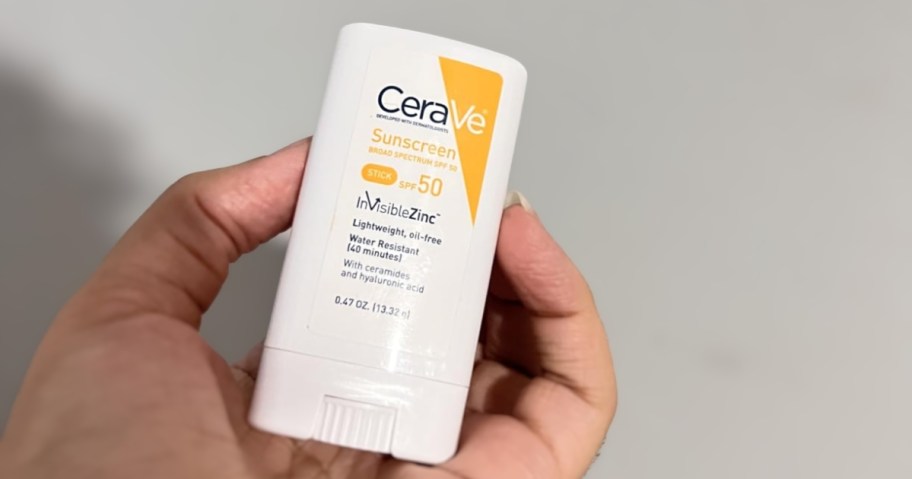 person holding cerave sunscreen stick with spf 50
