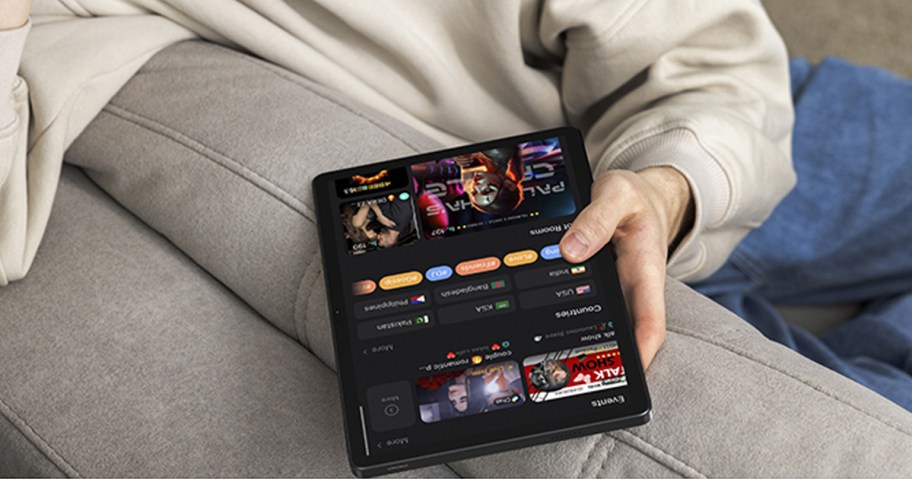 person sitting on couch holding a tablet