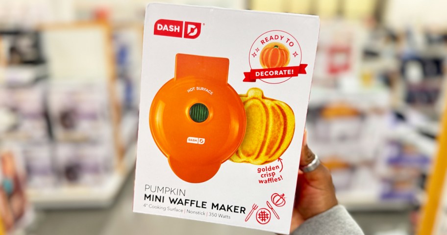 hand holding up Dash Pumpkin Mini Waffle Maker box in store