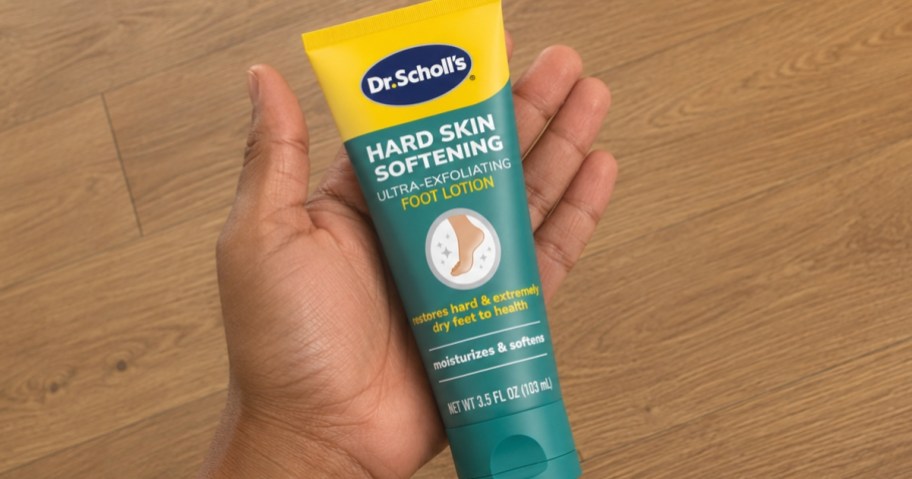 hand holding a tube of Dr. Scholl's Ultra Exfoliating Foot Cream