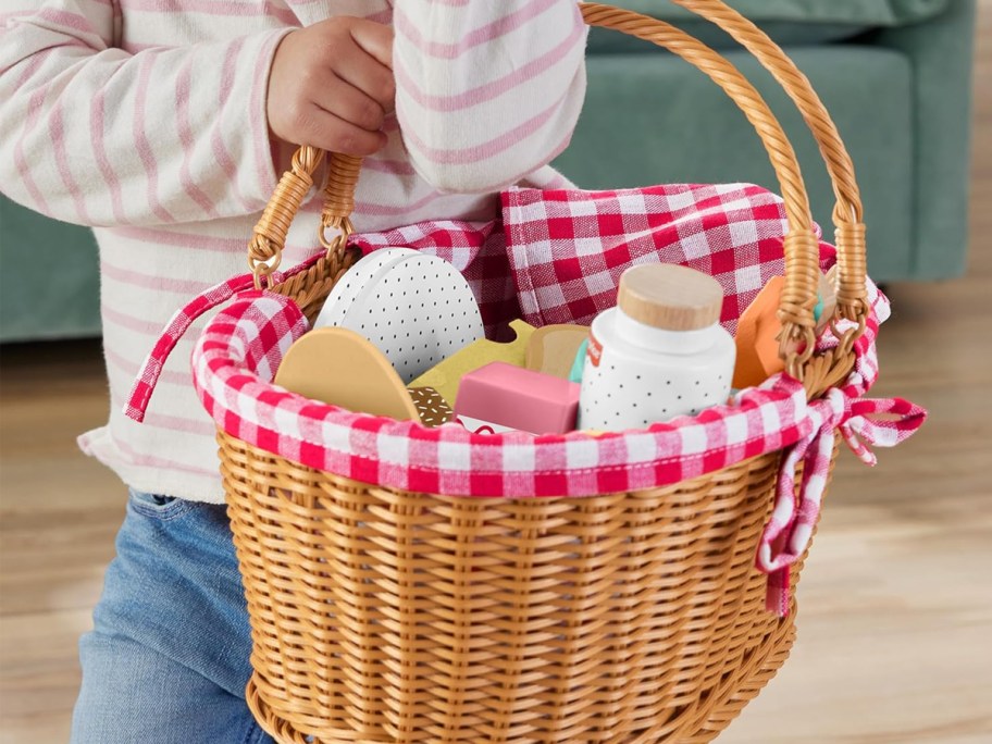 child carrying a picnic basket playset