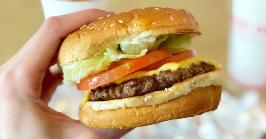 Hand holding a Five Guys Cheeseburger
